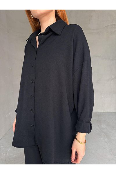 Cappmoda TKM-03662 قميص فضفاض بأكمام الخفافيش السوداء مع سروال بالازو عالي الخصر وربطة عنق طقم مكون من قطعتين