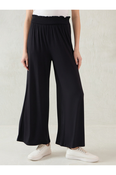 Femmella By Styli Black Smocked Waistband Flared Knit Pants