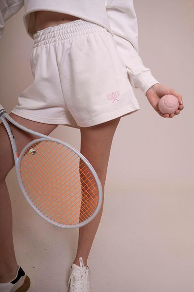 AFLOOW Delicate Women's Ecru Sports Shorts - Relaxed Fit, Stylish Tennis Racquet Detail