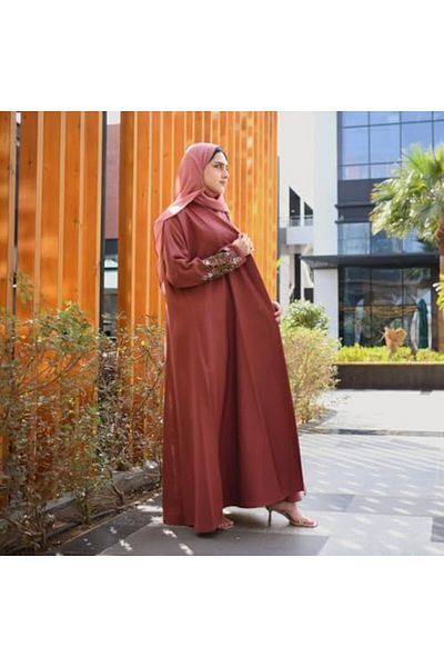 HAWRAA A soft orange quarter-length wrap abaya with hand embroidery on the sleeves.