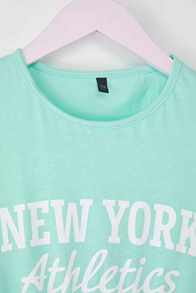 TRENDYOLKIDS Mätové dievčenské 100% bavlnené mini pletené šaty s krátkym rukávom a elastickým pásom TKDSS25EL00084