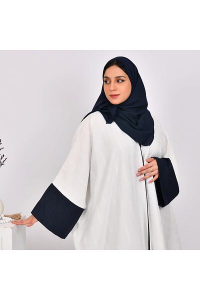 HAWRAA White abaya bisht with wide sleeves and a navy blue dress