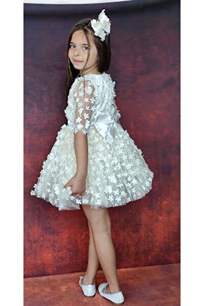 Riccotarz Kız Çocuk Kolları Şeffaf Tüllü ve Üzeri Papatya Motifli Beli Şerit Detaylı Krem Elbise