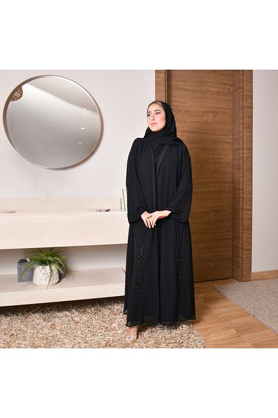 HAWRAA A quarter-length wrap abaya with black and pink embroidery on the edges and sleeves.