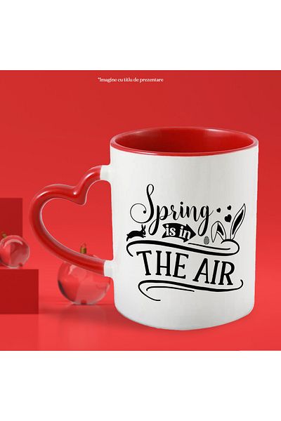 StoryGift Romania Mug with illustration showing a bunny, hearts and the message "Spring is in the ai, Cu ,STG .