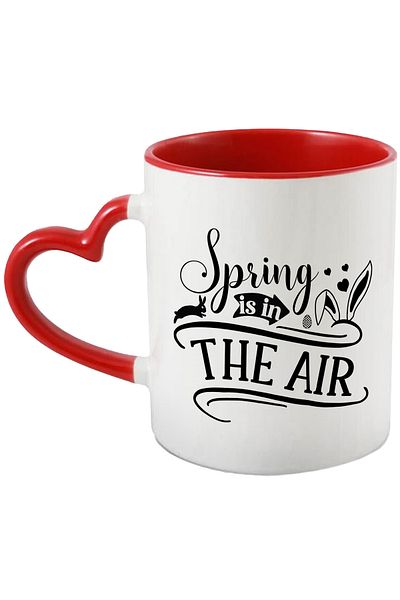 StoryGift Romania Mug with illustration showing a bunny, hearts and the message "Spring is in the ai, Cu ,STG .
