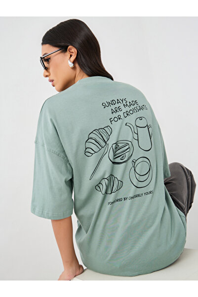 Styli تي شيرت كبير الحجم بطبعة جرافيكية على شكل كرواسون وأكتاف منسدلة