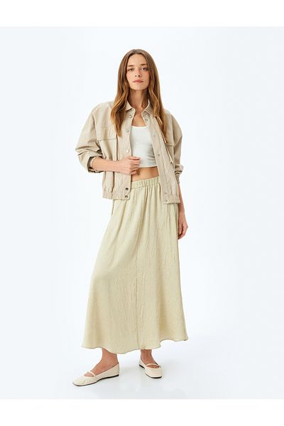 Koton Relax fit high-rise textured long satin flared skirt.