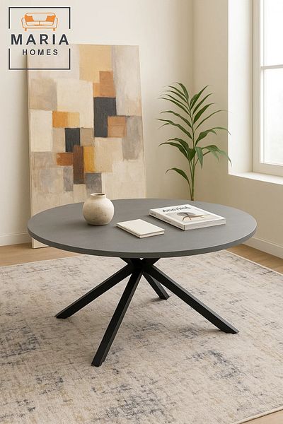 MARIA HOMES Minimalist round stone-look table with black cross base