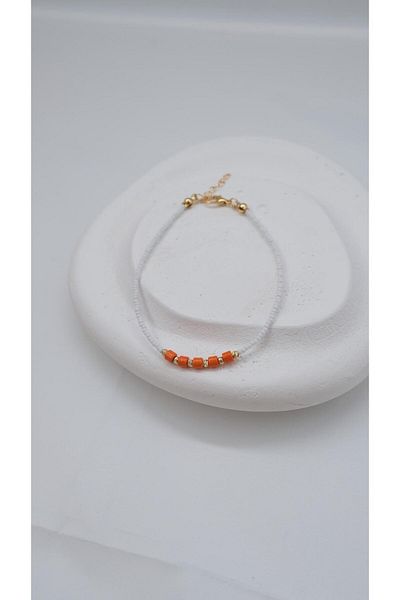 Jerie White Anklet with Orange Beads and Dorica Detail