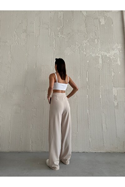 modazoom Damskie kremowe spodnie palazzo z plisami z wysokim stanem i lycrą