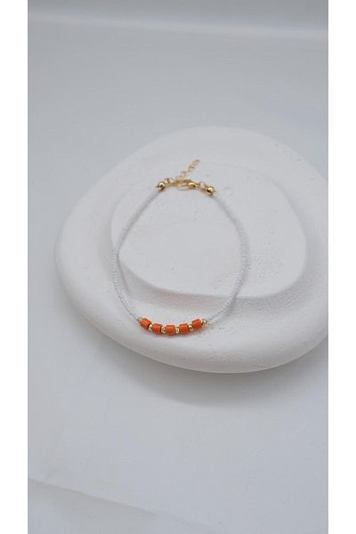 Jerie White Anklet with Orange Beads and Dorica Detail