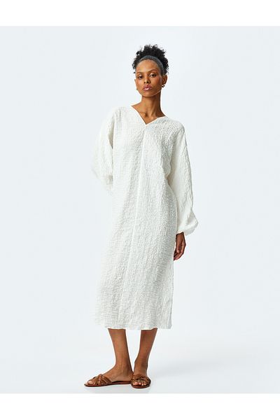 Koton Loose-fit long balloon sleeve V-neck textured midi dress.