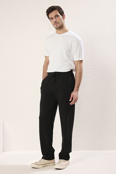 Trendyol Collection Černé košilkové kalhoty z pružné pleteniny - pohodlný střih TMNSS25PL00005