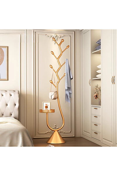 Un Modern tree branch design clothes rack with a gold base and side table.