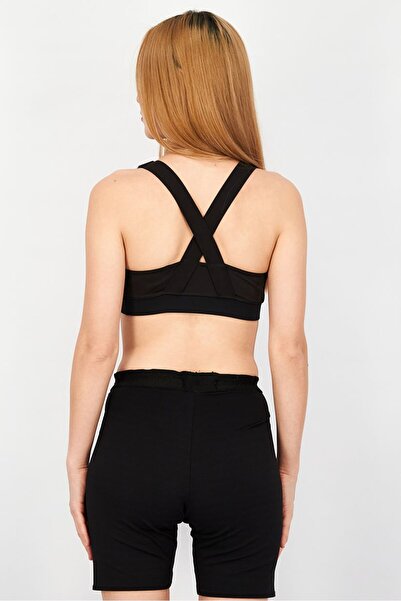 Puma حمالة صدر رياضية مبطنة بطبعة جرافيكية للنساء، لون أسود