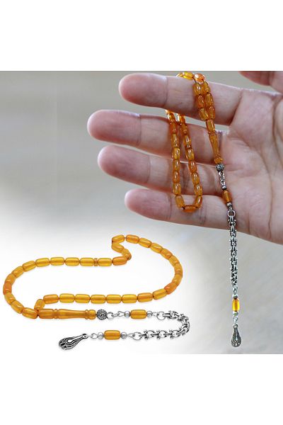 Tesbihane سلسلة معدنية متدلية من نوع Albanian Chain، مقصوصة على شكل كبسولة، لون عسلي، بطول المعصم، مسبحة من العنبر الناري