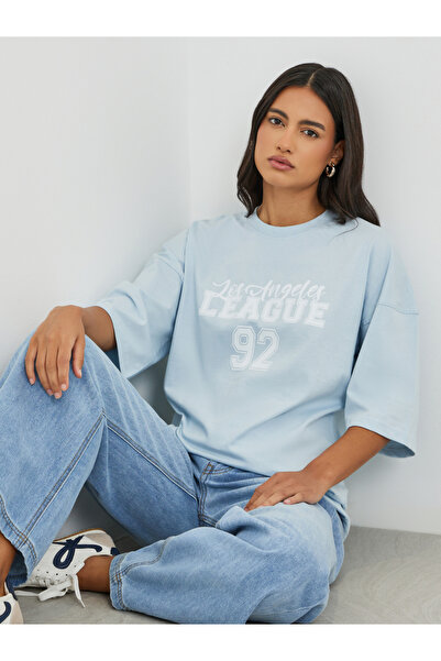 Styli تي شيرت كبير الحجم بطباعة شعار وأكتاف مبالغ فيها