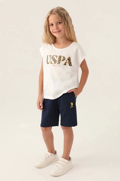 U.S. Polo Assn. بدلة برمودا للفتيات باللون الكريمي المكتوب عليها زهور مرخصة