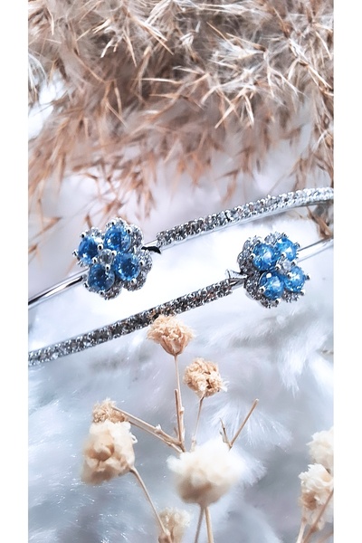 Serenity سوار من الفولاذ على شكل زهرة من حجر الزركون الأزرق