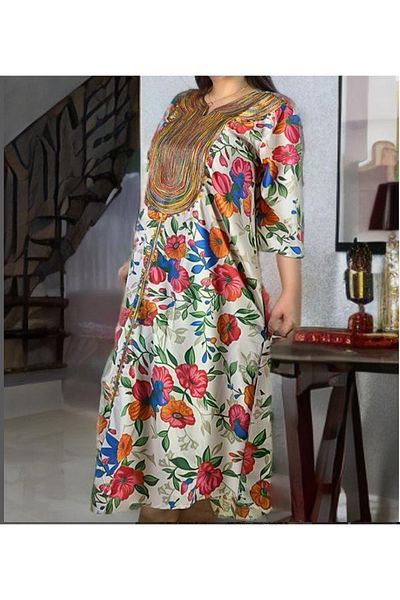 Lyaly aljlabyh The "Flowers of Paradise" caftan is a loose summer dress with a tropical floral print and colorful embroidery on the chest, for a cheerful and modern look.