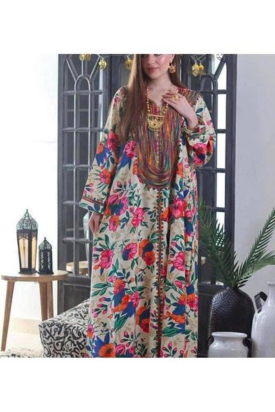 Lyaly aljlabyh The "Flowers of Paradise" caftan is a loose summer dress with a tropical floral print and colorful embroidery on the chest, for a cheerful and modern look.