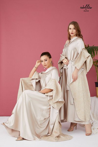 Stylish Elegant dress with a distinctive design in beige with one shoulder sleeves