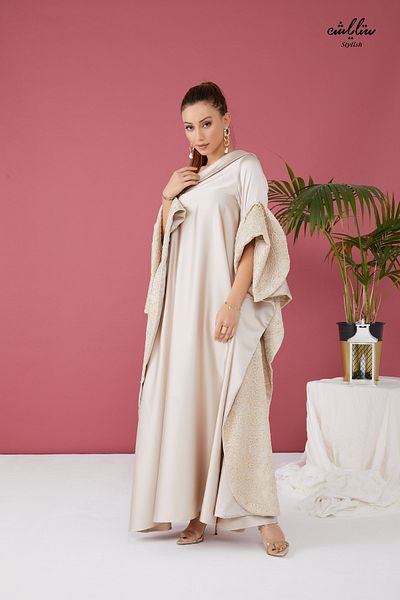 Stylish Elegant dress with a distinctive design in beige with one shoulder sleeves
