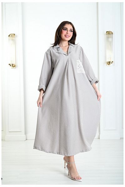 Lyaly aljlabyh "Elegance Lines" Jalabiya, a black and white striped dress with a modern design and an embroidered pocket, for an elegant and practical everyday look.