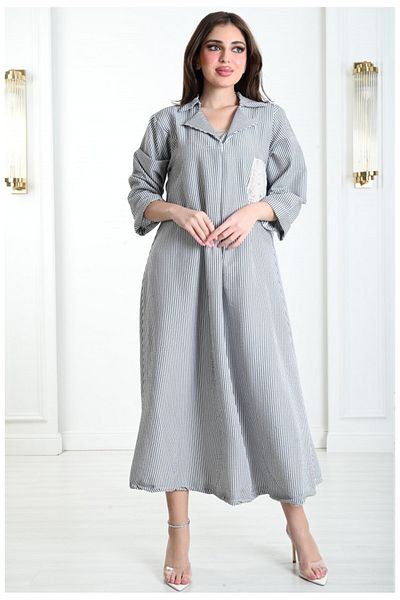 Lyaly aljlabyh "Elegance Lines" Jalabiya, a black and white striped dress with a modern design and an embroidered pocket, for an elegant and practical everyday look.