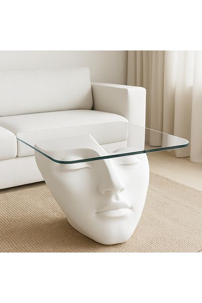 VİSAGE Sculptural coffee table with an abstract human face base and elegant top.