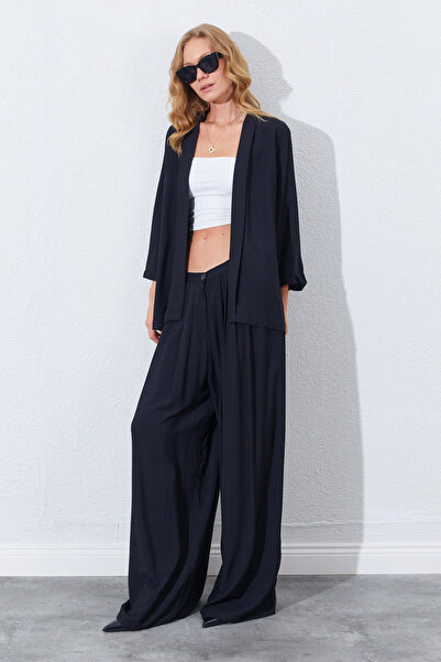 Manche Μαύρο παντελόνι παλάτσο με ψηλή μέση, φαρδιά μπατζάκια και ντραπέ εφέ ...