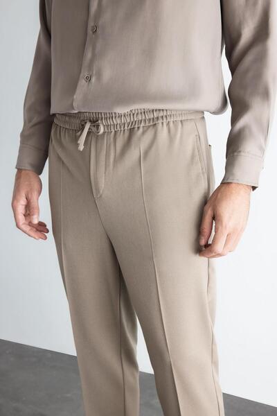 DeFacto Yazlık Kumaş Jogger Pantolon Beli Bağcıklı Lastikli Düz Paça Cepli Her Yöne Esneyen A9943ax24au