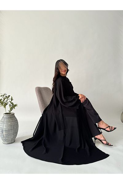outline Black quarter-cloche abaya set with black rose embroidery and a dress underneath the abaya