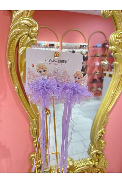 La She Accessories Elsa figure with angel wing detail, long ribbon, 2 clip-on hairpins.
