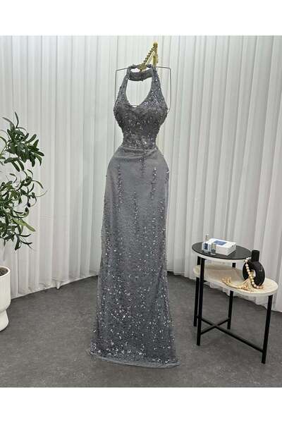 Afnan Boutique Mermaid-style evening dress in a shiny gray color.