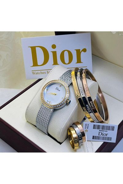 di Dior watch with three bracelets and rings