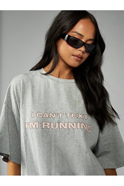 Kaptins Women's T-Shirt with the Message, "I'M Running, I Can'T Write" Printed on It.