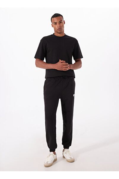 Reebok LC 9066 NEW ID OVRS GFX JOGGER Siyah Lastikli Bel Regular Fit Düz Erkek Eşofman Altı