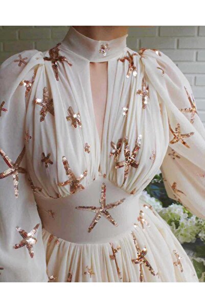 MorooJ Long cream evening dress embroidered with bronze sequin stars