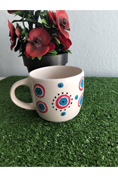 Home Coffee Cup with Red Ornament and Evil Eye Design.