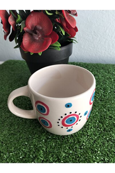 Home Coffee Cup with Red Ornament and Evil Eye Design.