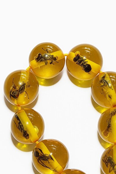 AURA A prayer rosary made of powdered amber in the shape of spherical, cut ant fossils