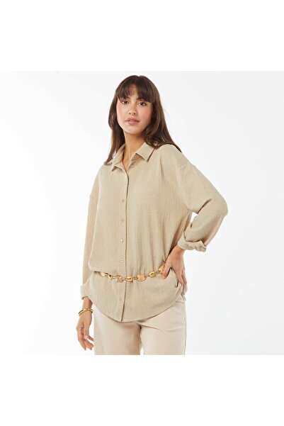 KIABI بلوزة قصة فضفاضة من قماش محبوك مجعد باللون البيج