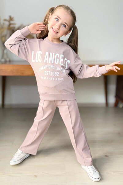 Riccotarz Κοριτσίστικο σετ αθλητικής φόρμας με λεπτομέρεια Los Angeles, με μανσέτες στα καρπά, φαρδιά εφαρμογή, σε σκόνη