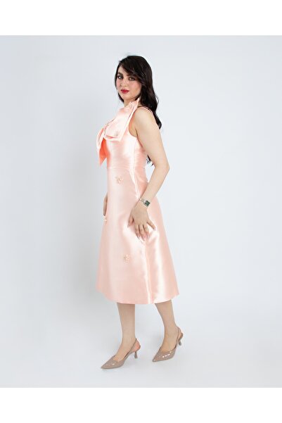 NATASHA Fashion Natasha Mikado's dress is pink with a bow on the chest and el...