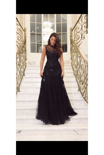 Riva The elegant black dress features a long design.