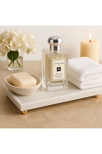 Modestmar Natural beige marble rectangular tray with gold ball feet.