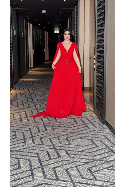 Riva Long, flowing red evening dress with an elegant cape cut and a deep neckline