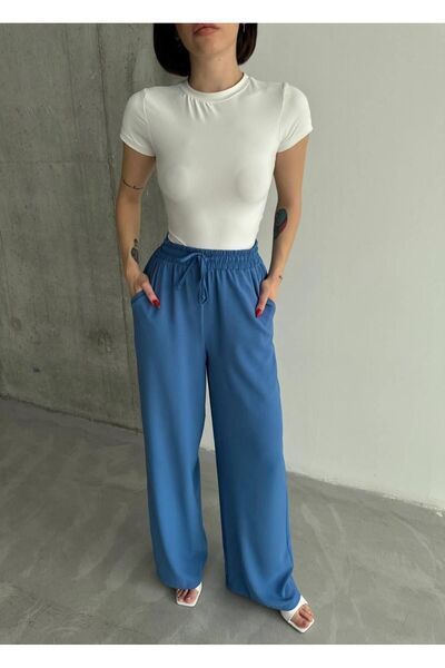 MADAME MELEK بنطلون ليندا من القماش الكتاني الأسود المخلوط ذو قصة فضفاضة مع أ...